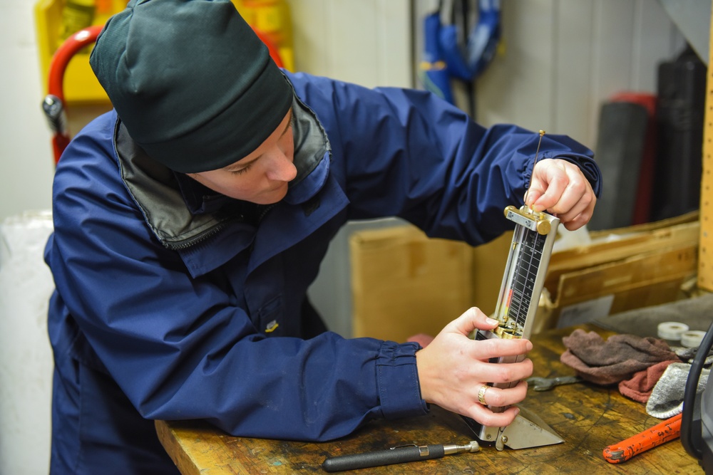 Coast Guardsman conducts daily vessel oil test