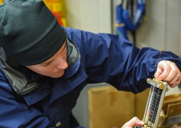 Coast Guardsman conducts daily vessel oil test