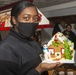 USS Constitution Sailors decorate gingerbread houses for the holidays