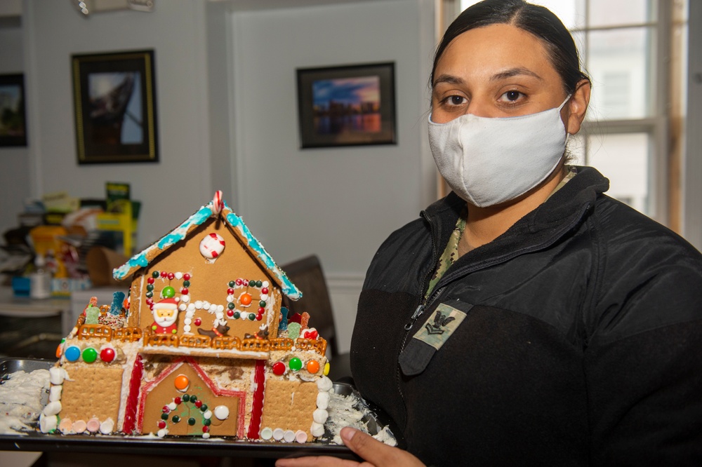 USS Constitution Sailors decorate gingerbread houses for the holidays