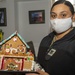 USS Constitution Sailors decorate gingerbread houses for the holidays