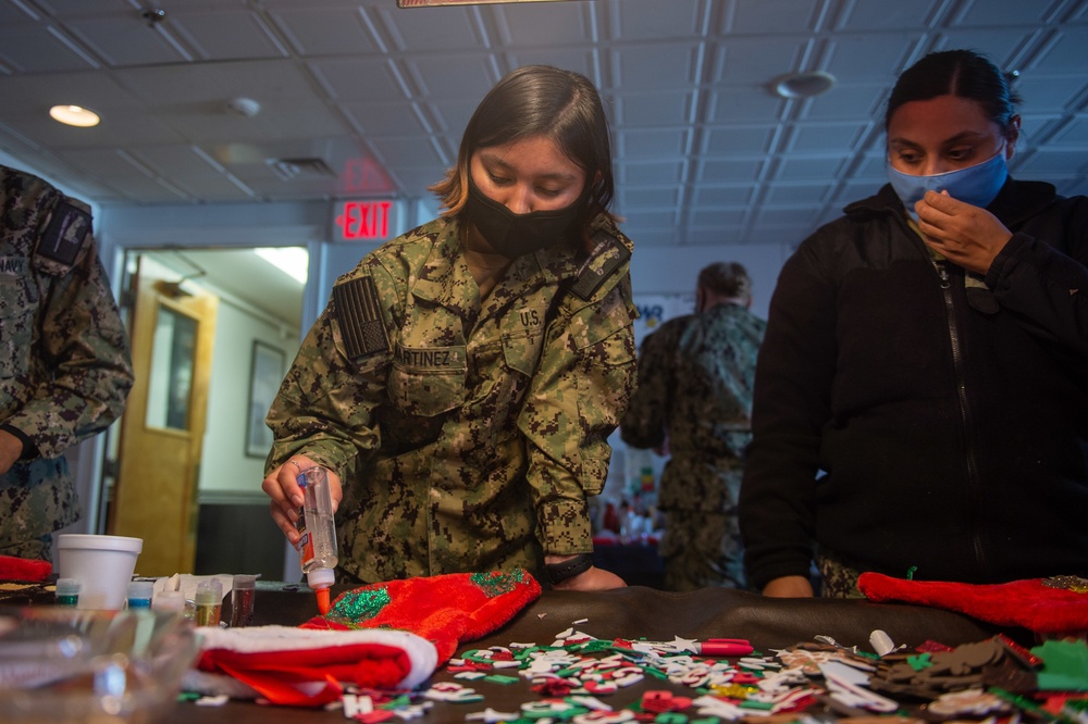 USS Constitution Sailors decorate stockings for the holidays