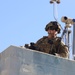 25ID Soldier watches for enemy movements from roof of building at JRTC