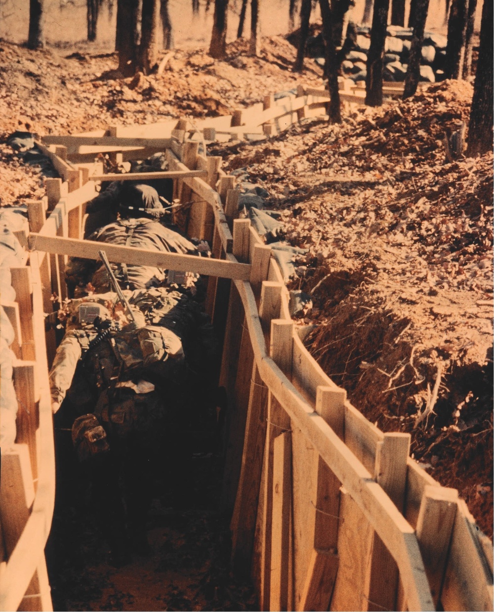 Soldiers maneuver through trench durin a JRTC rotation at Fort Chaffee