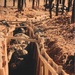 Soldiers maneuver through trench durin a JRTC rotation at Fort Chaffee