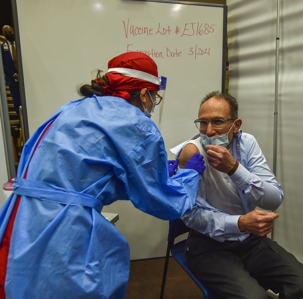 Dr. Charles Faselis receives the first Pfizer COVID-19 vaccine injection at DC VAMC
