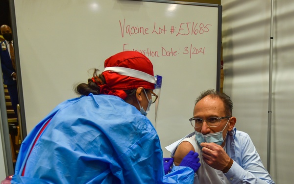 Dr. Charles Faselis receives the first Pfizer COVID-19 vaccine injection at DC VAMC
