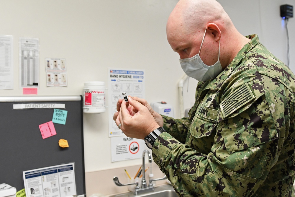 HM2 Timothy Maddox Prepares to Deliver the First COVID-19 Vaccine at NHCH