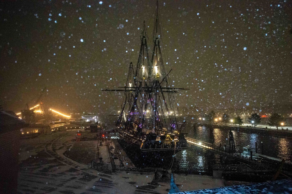 USS Constitution is moored to the pier during a snow storm