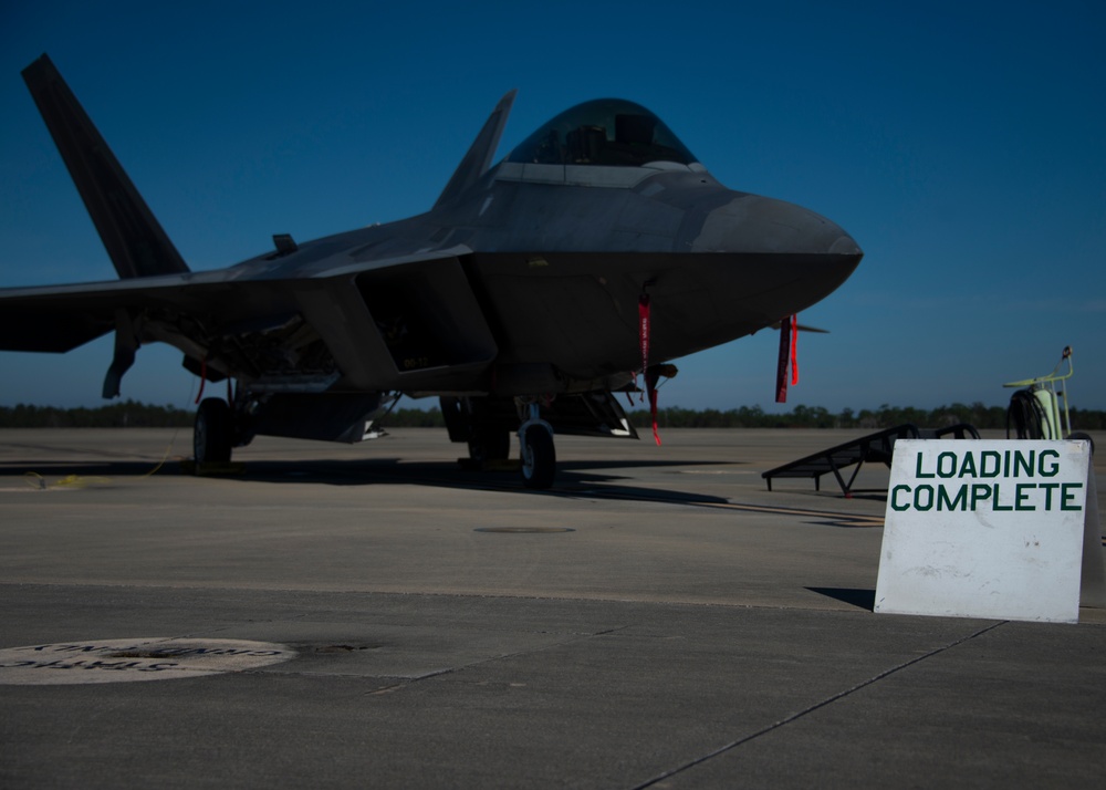 Team Tyndall Airmen load AIM-9 missiles on F-22s