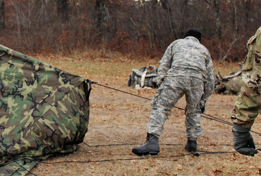 Cold-Weather Operations Course students practice building Arctic tent