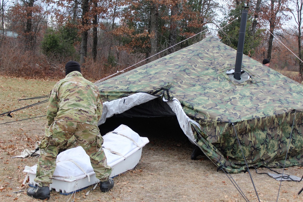 Cold-Weather Operations Course students practice building Arctic tent