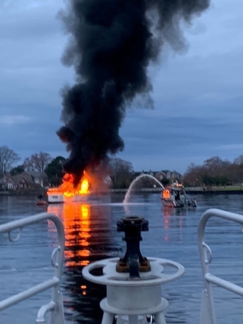 Coast Guard, Navy, and local municipalities coordinate to save man from burning vessel