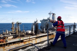French Navy Sailor fires a shot line during refueling-at-sea