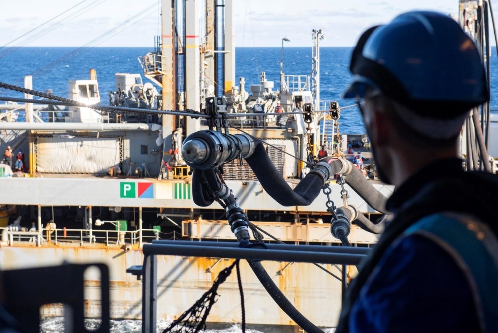 French Navy Sailor observes fuel probe during underway replenishment
