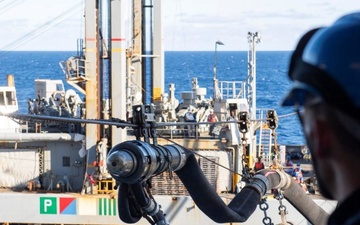 French Navy Sailor observes fuel probe during underway replenishment