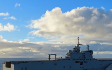 French Navy LHD Dixmude sails off after completing replenishment-at-sea with U.S. Navy USNS Laramie