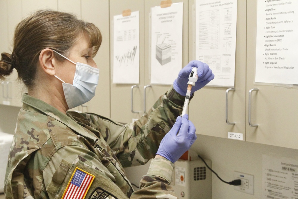 U.S. Army Arizona National Guard Ltc. Joana Shoffner the states immunization officer prepares the first round of the Moderna vaccine.