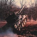 Tank speedly driving up enbankment at late 1980's JRTC at Fort Chaffee, AR