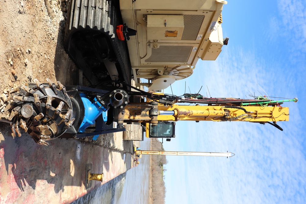 Hydrodynamic dredge attached to track-hoe