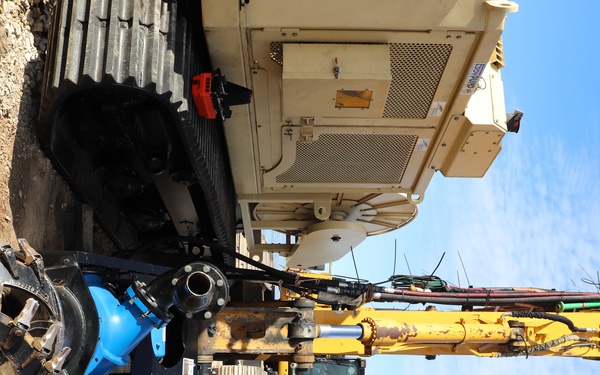 Hydrodynamic dredge attached to track-hoe