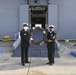 USS America (LHA 6) receives kadomatsu from JS Ise (DDH 182)
