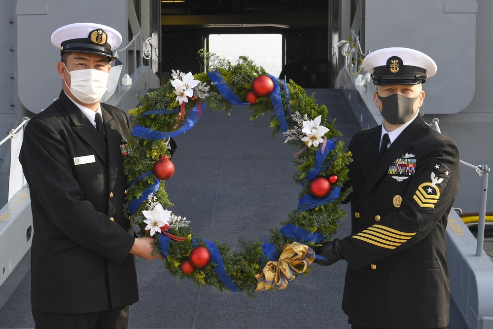 USS America (LHA 6) receives kadomatsu from JS Ise (DDH 182)