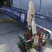 USS America (LHA 6) receives kadomatsu from JS Ise (DDH 182)