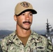 Sailor Poses for Portrait Aboard USS Emory S. Land in Kure