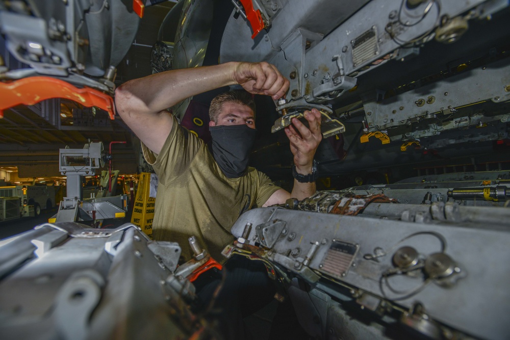 Aviation Ordnanceman Prepares Bomb Rack Aboard USS Nimitz CVN 68