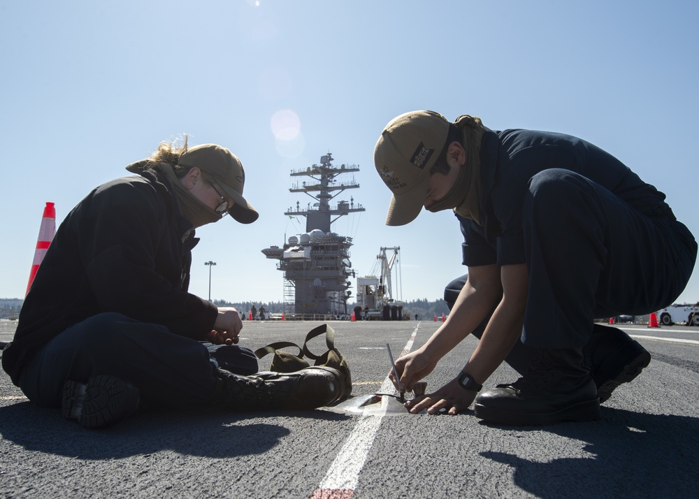 Nimitz Sailors Change Light On Flight Deck