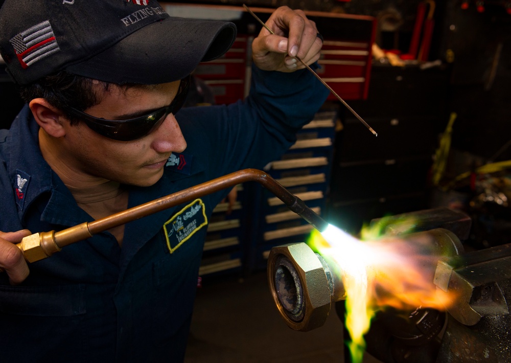 Nimitz Sailor Braises a Pipe