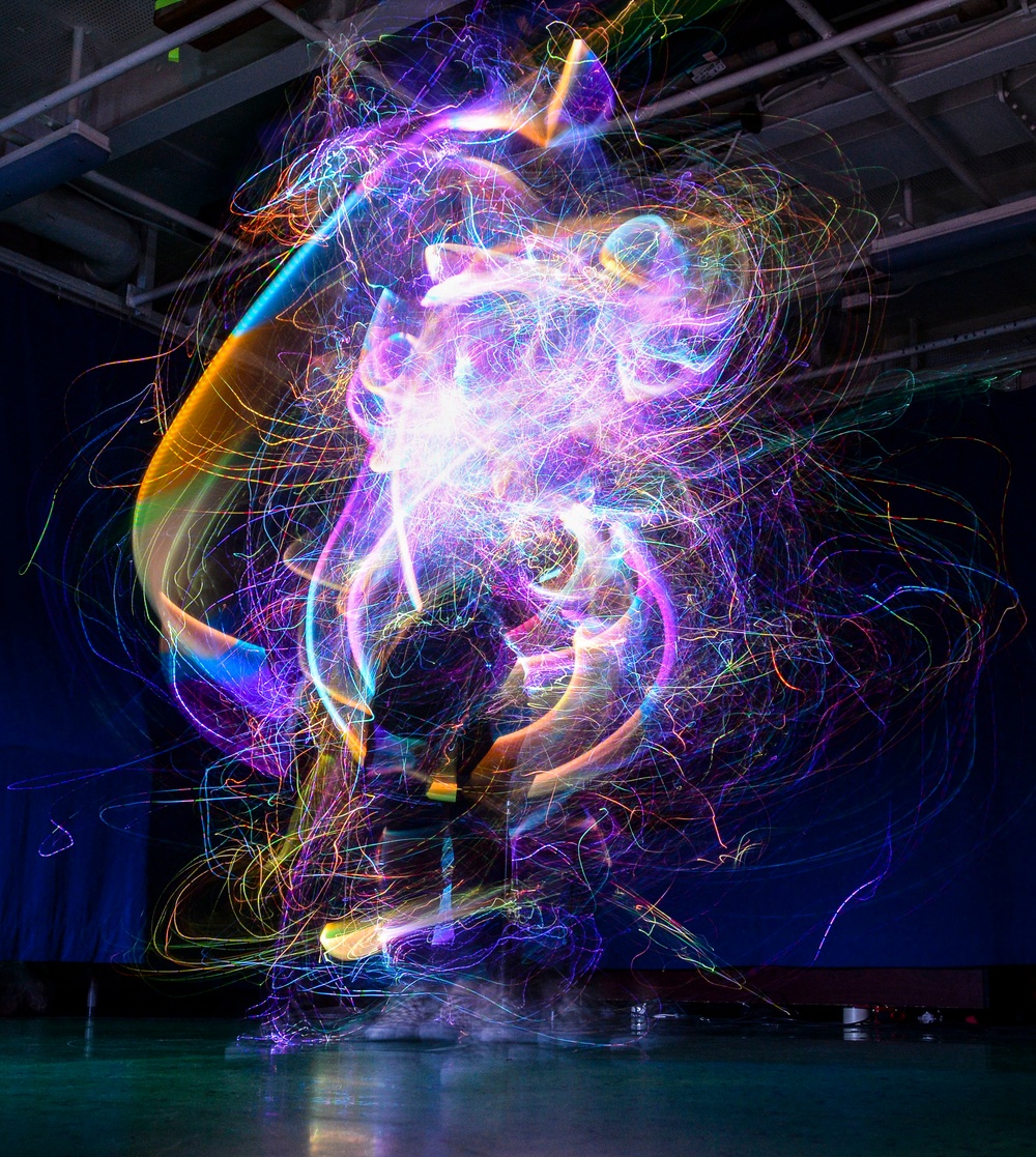 Gunner's Mate Performs With A &quot;Glow Whip&quot; During Nimitz Talent Show