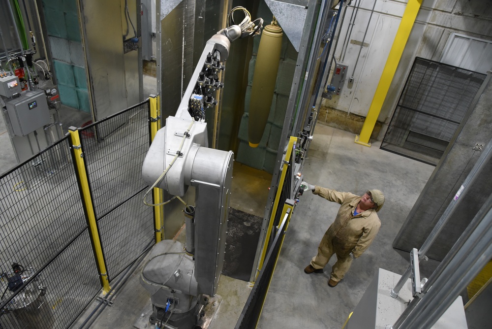 Paint robot applying paint to an MK82 general-purpose bomb body at McAlester Army Ammunition Plant
