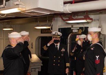 Capt. Cassidy Norman arrives, as part of the official party aboard the aircraft carrier John C. Stennis (CVN 74), during a change of command ceremony held in the forecastle.