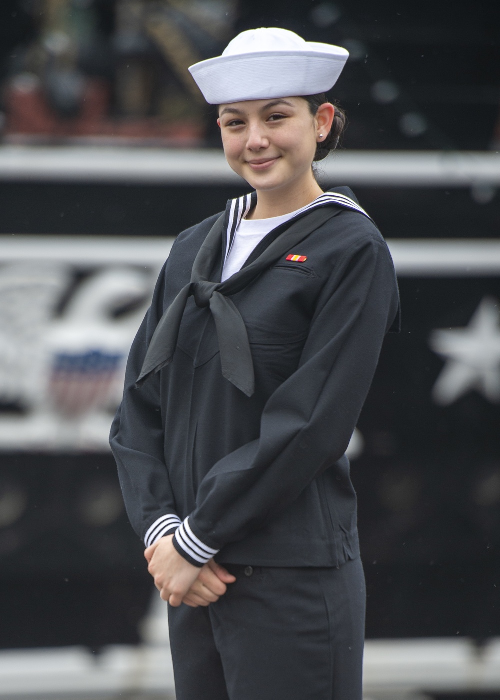 Airman Melanie Santos poses for a photo in front of USS Constitution