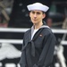 Airman Paul Stickney poses for a photo in front of USS Constitution