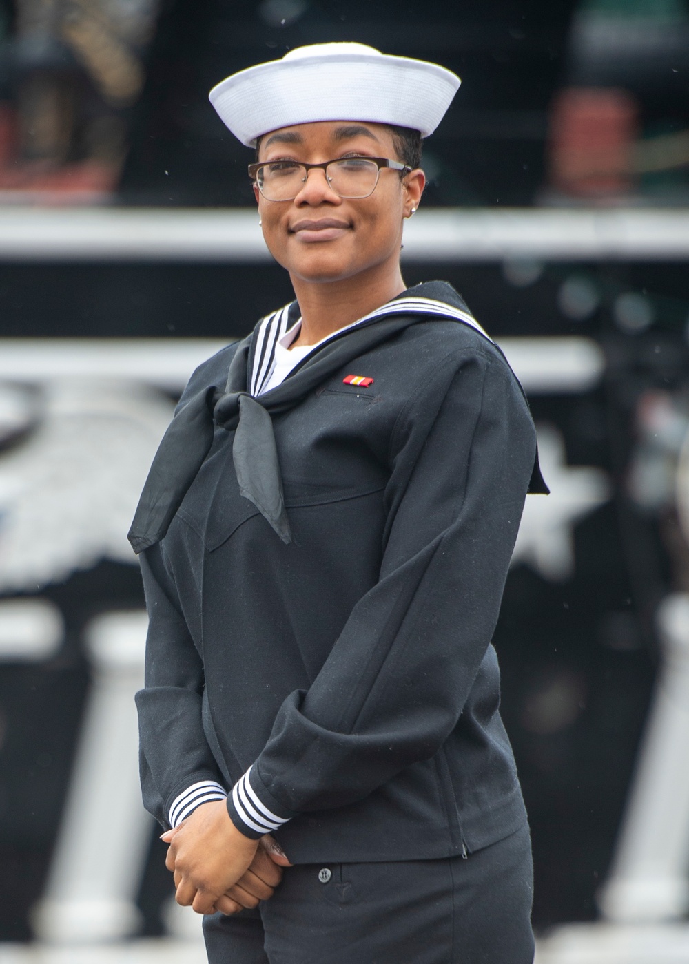 Airman Tasheyana Harden poses for a photo in front of USS Constitution