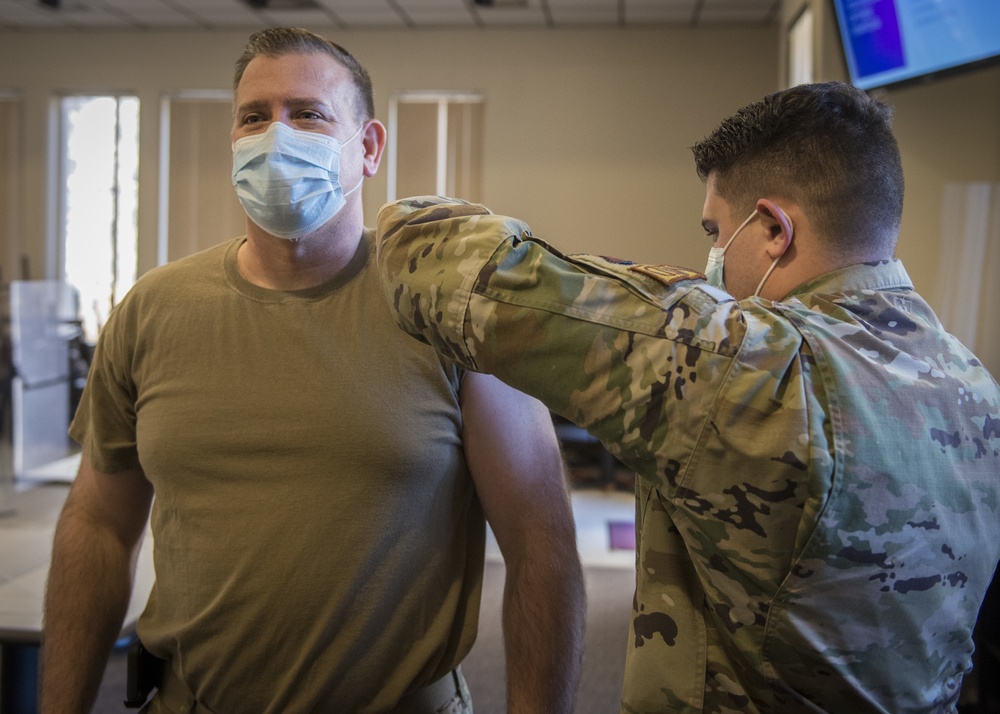 Guardsman administers COVID-19 vaccine to his father
