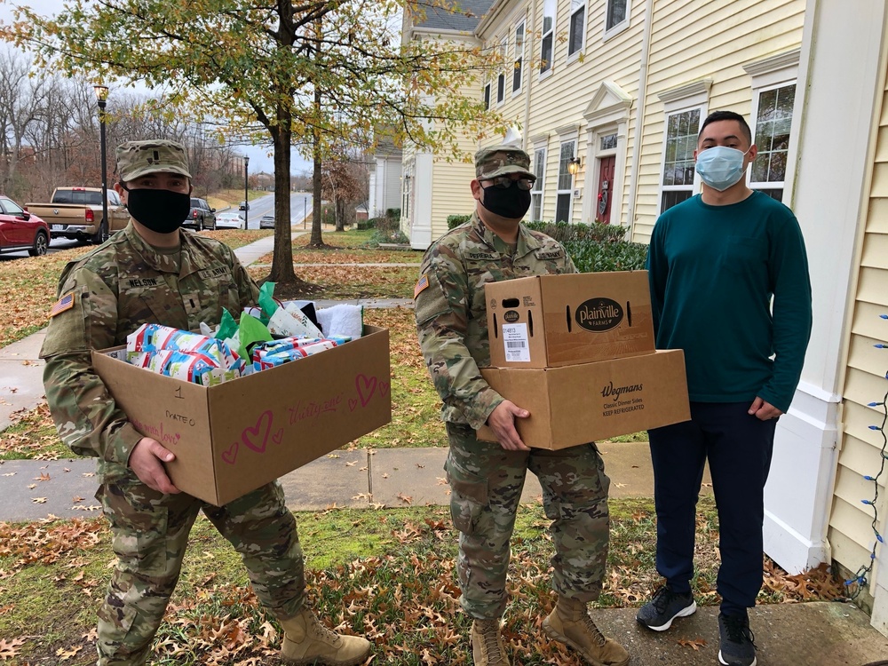 Soldiers within the DCS G6 and CIO delivering meals and gifts to local soldiers in need