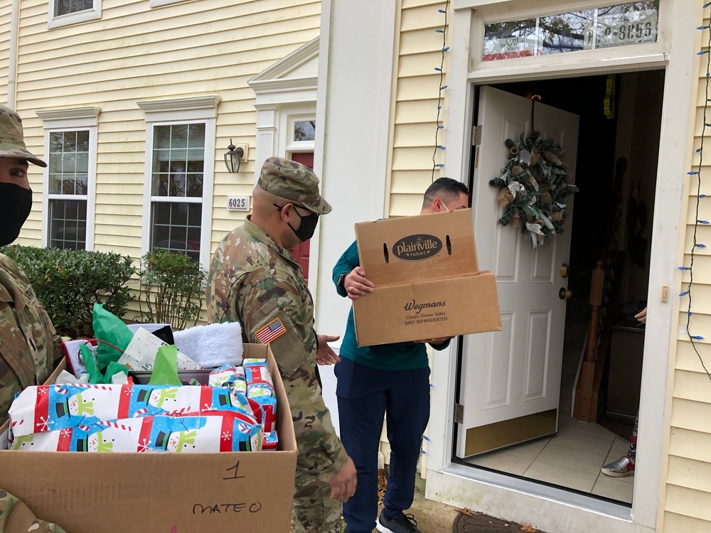 Soldiers within the DCS G6 and CIO delivering meals and gifts to local soldiers in need