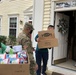Soldiers within the DCS G6 and CIO delivering meals and gifts to local soldiers in need