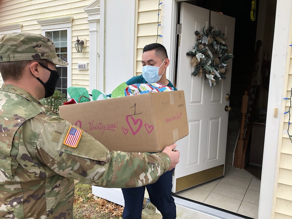 Soldiers within the DCS G6 and CIO delivering meals and gifts to local soldiers in need