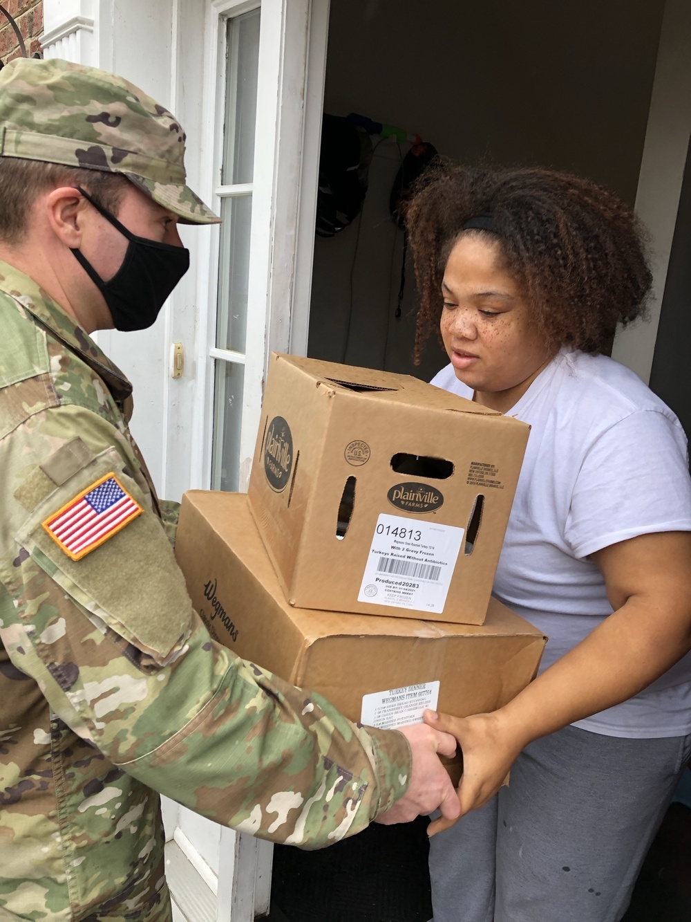 Soldiers within the DCS G6 and CIO delivering meals and gifts to local soldiers in need