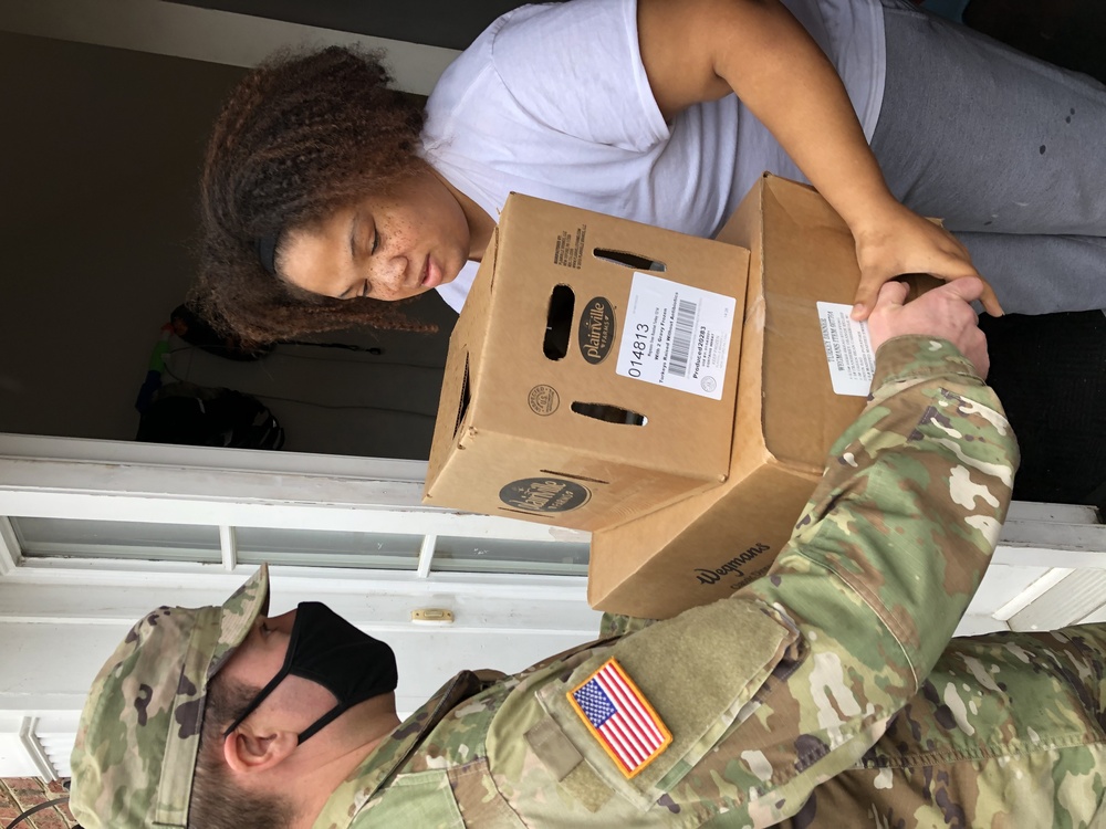 Soldiers within the DCS G6 and CIO delivering meals and gifts to local soldiers in need