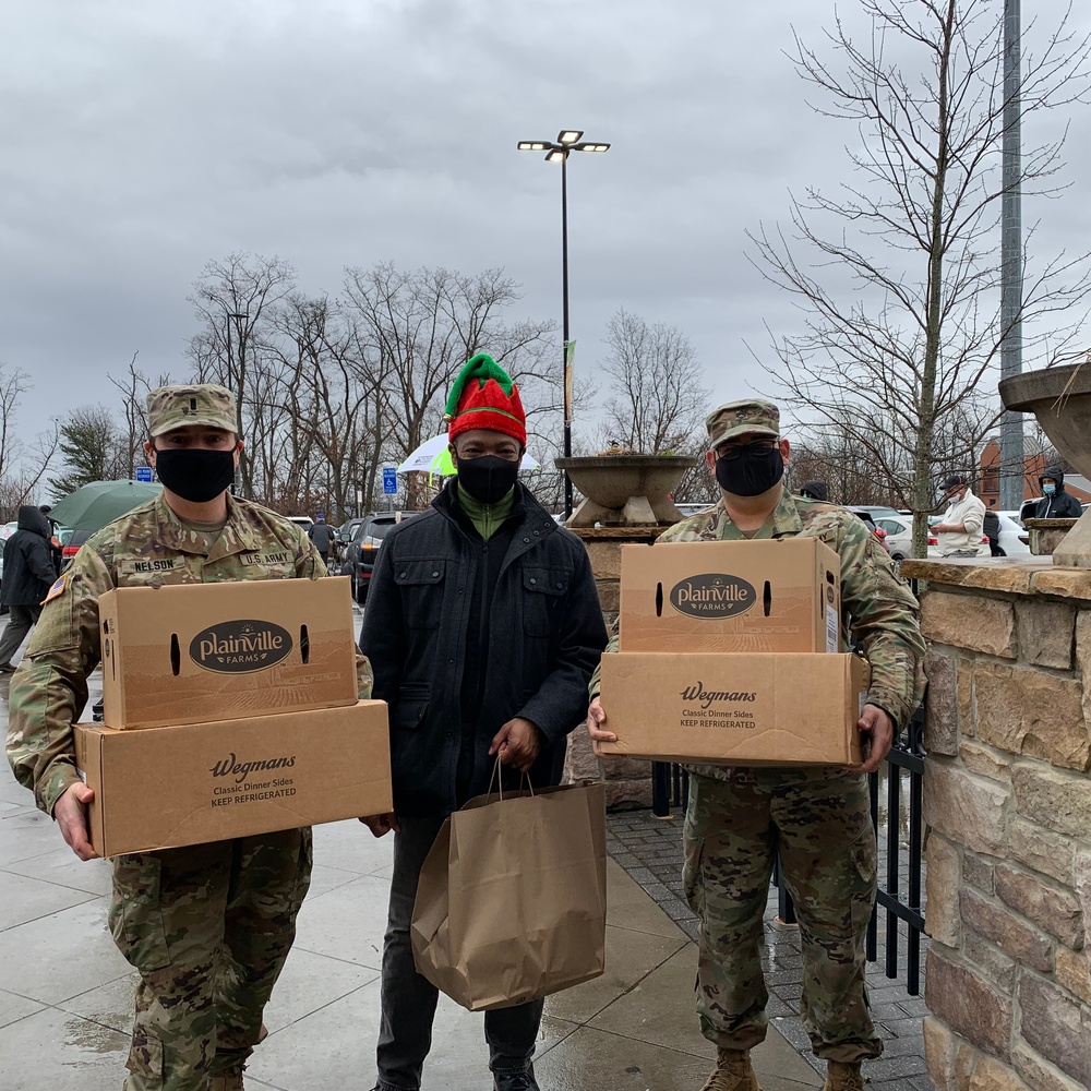 Soldiers within the DCS G6 and CIO delivering meals and gifts to local soldiers in need