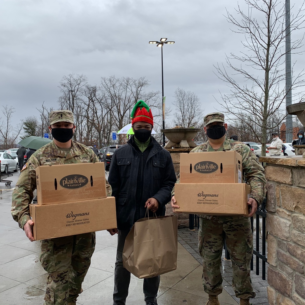 Soldiers within the DCS G6 and CIO delivering meals and gifts to local soldiers in need