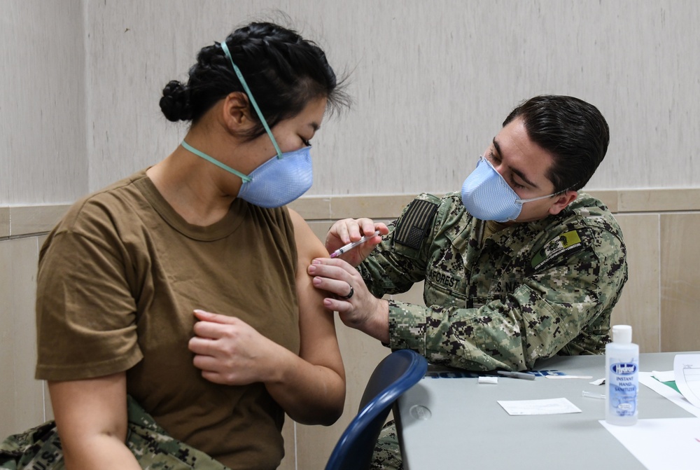 Lt. Cmdr. Kelly Peng, an emergency medicine physician assigned to U.S. Naval Hospital (USNH) Naples, receives the Moderna coronavirus (COVID-19) vaccine