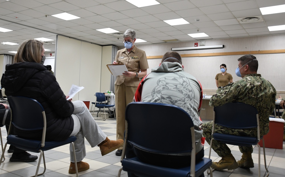 Lt. Cmdr. Karen Downer, assigned to U.S. Naval Hospital (USNH) Naples, gives medical staff a brief on the Moderna coronavirus (COVID-19) vaccine