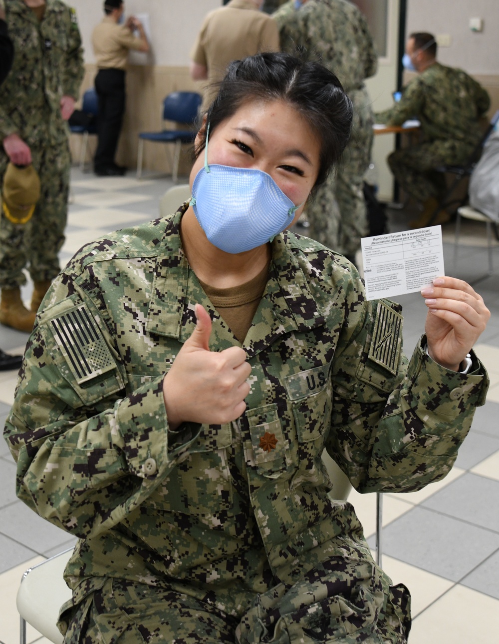 Lt. Cmdr. Kelly Peng, an emergency medicine physician assigned to U.S. Naval Hospital (USNH) Naples, is all smiles after completing the Moderna coronavirus (COVID-19) vaccine observation period